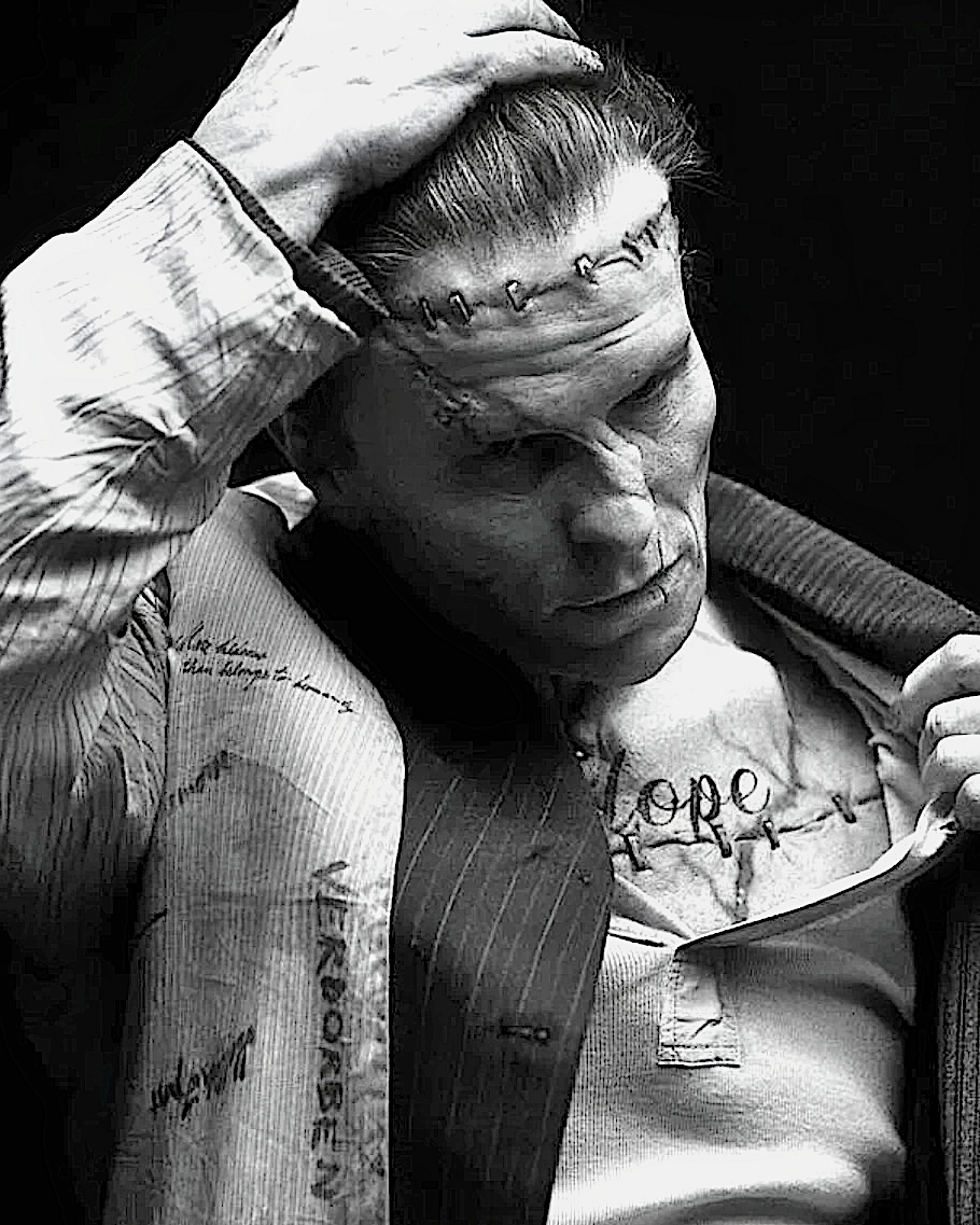 black and white photo of actor Christian Bale in special makeup for the Frankenstein role