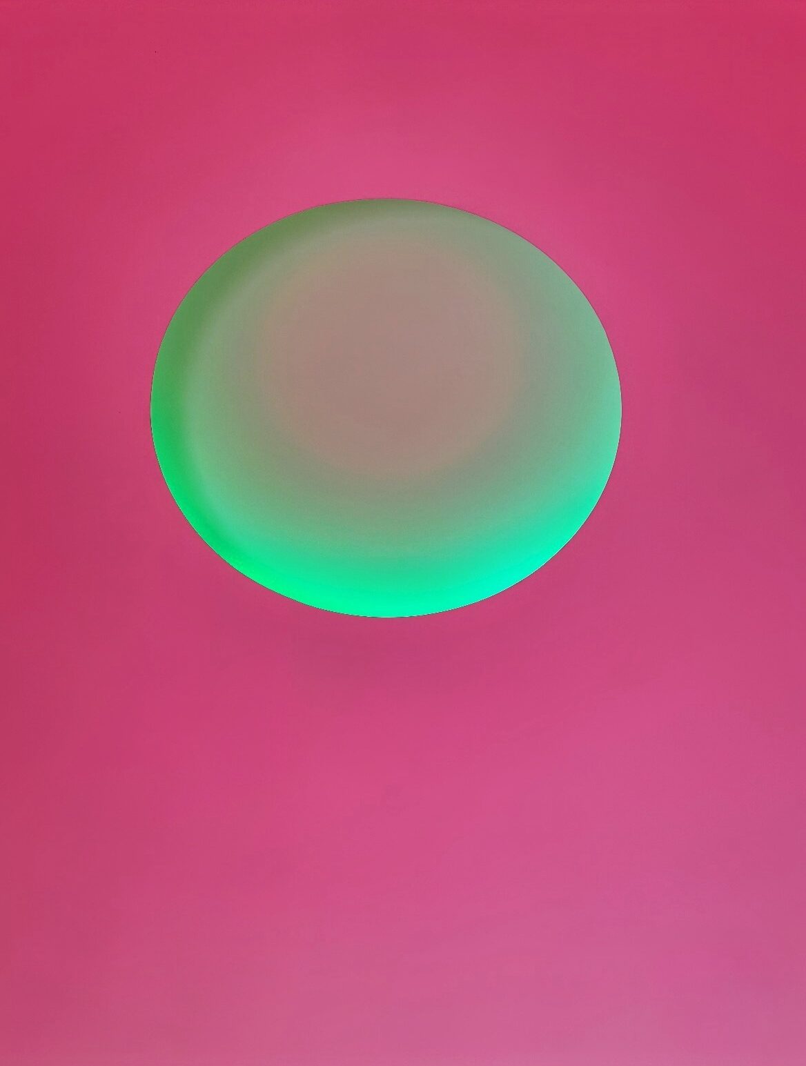 A green orb on a pink background